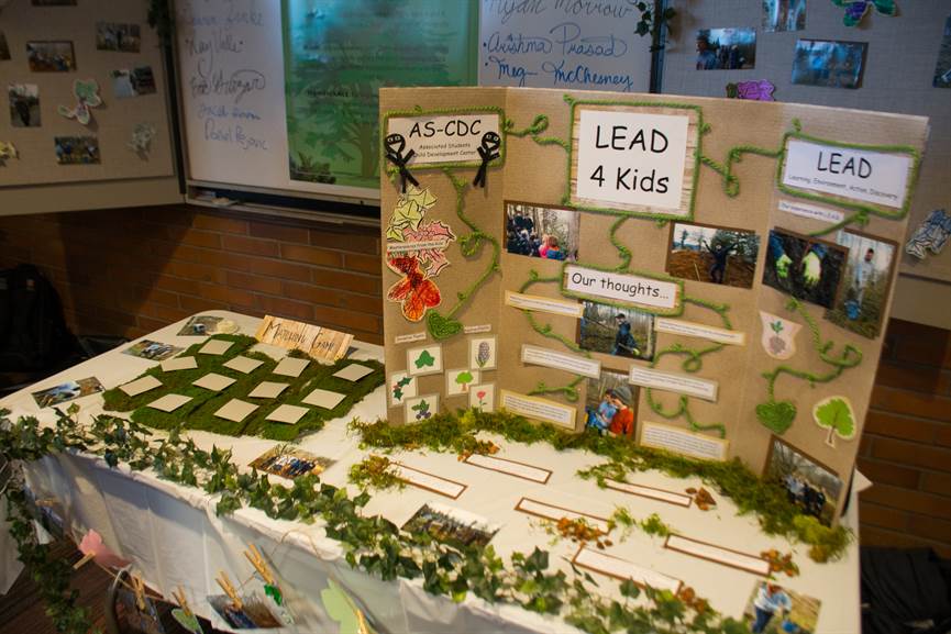 Table with tri-fold poster titled "LEAD (Learning, Environment, Action, Discovery) for Kids"
