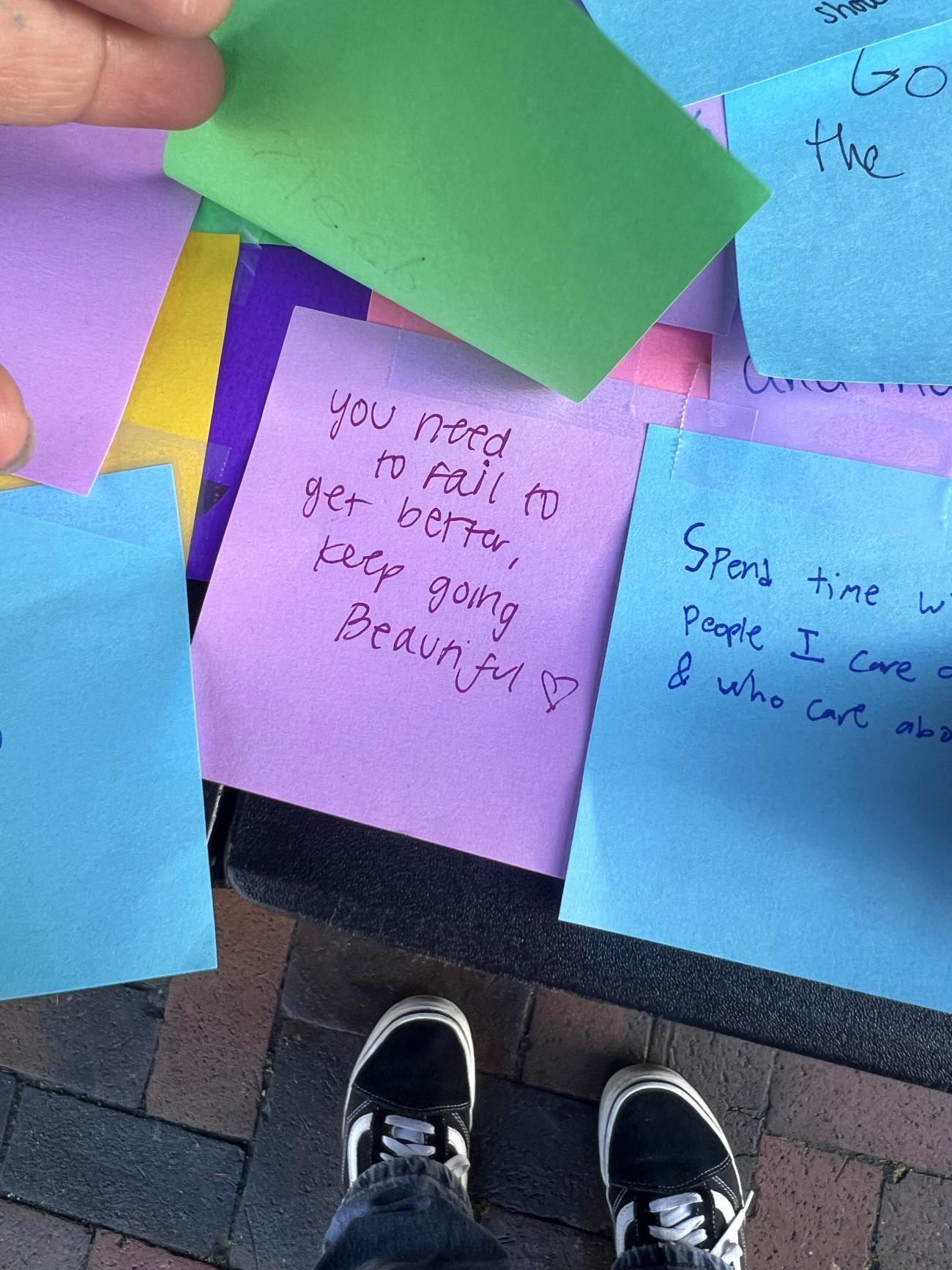 close up of stick notes with handwritten notes written on them, the one in the center says 'you need to fail to get better, keep going beautiful'