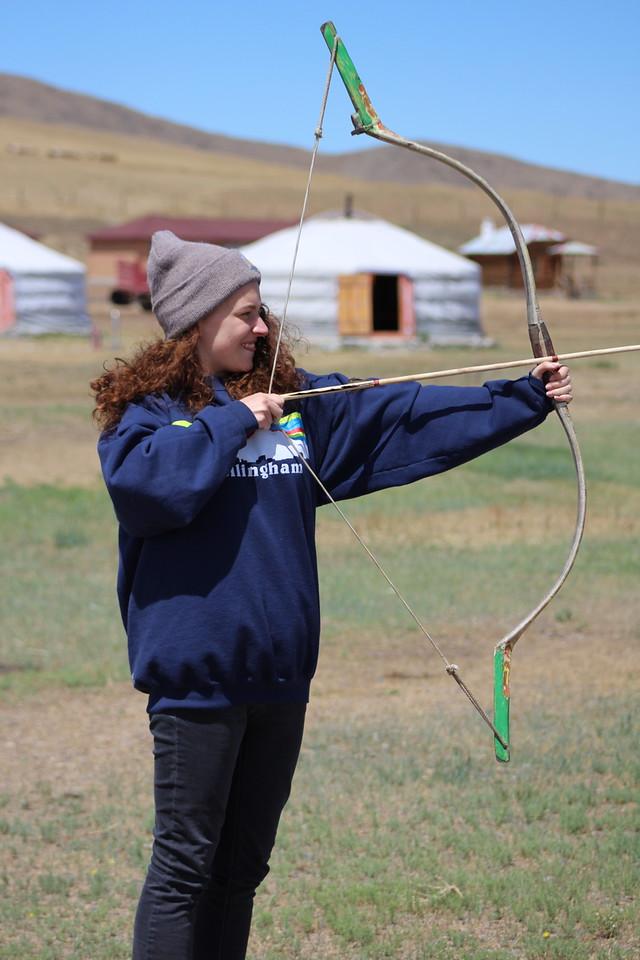 person preparing to shoot an arrow with a bow